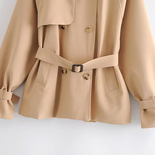 Women Short Tailored Trench Coat with Tied Belt, Asymmetrical Storm Flap and Cuff Strap Amarae
