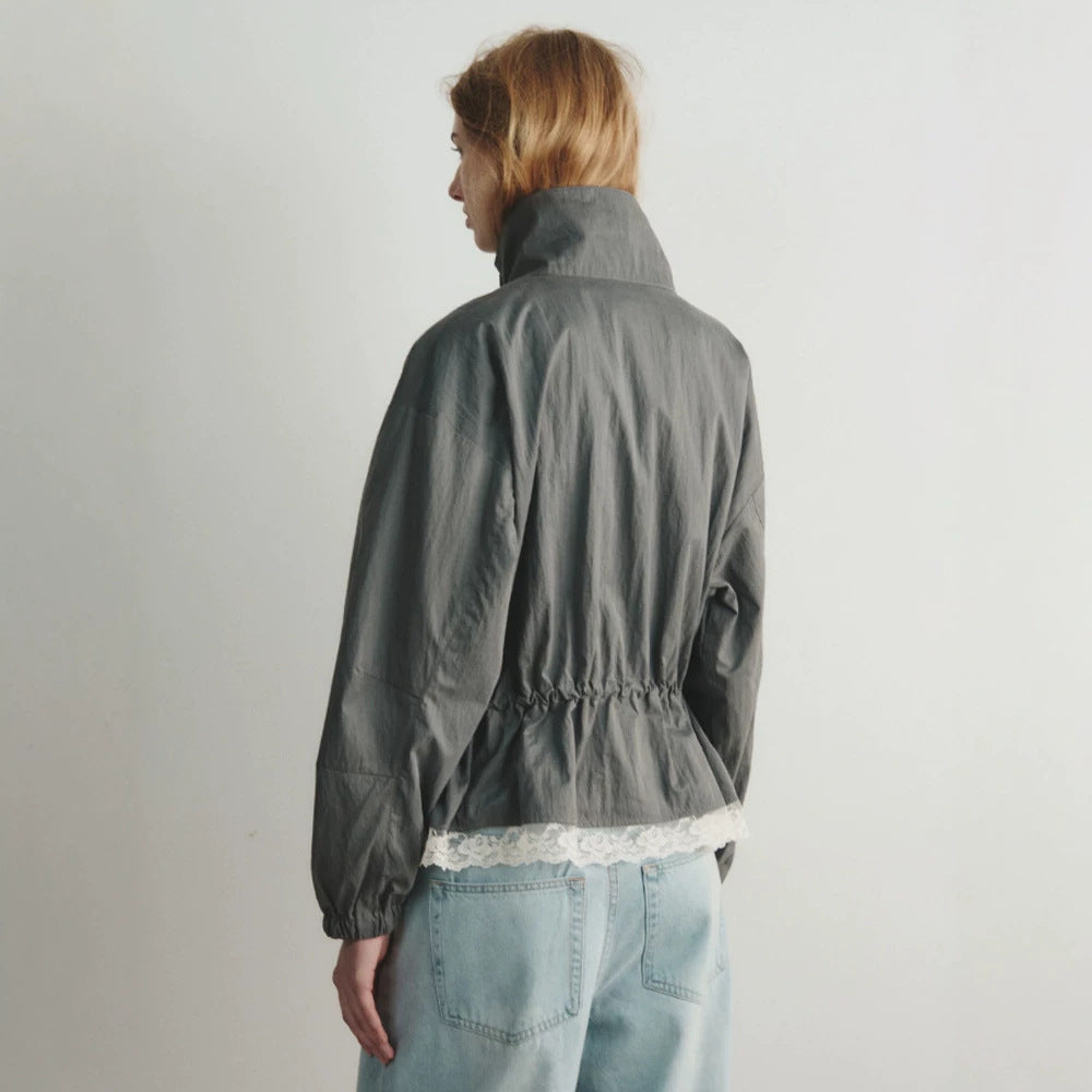 Women's oversized windbreaker with high stand-up collar, drawstring waist, and elastic cuffs