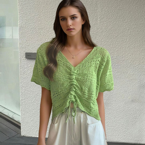 Women's knit top with decorative hole pattern and adjustable hem Amarae