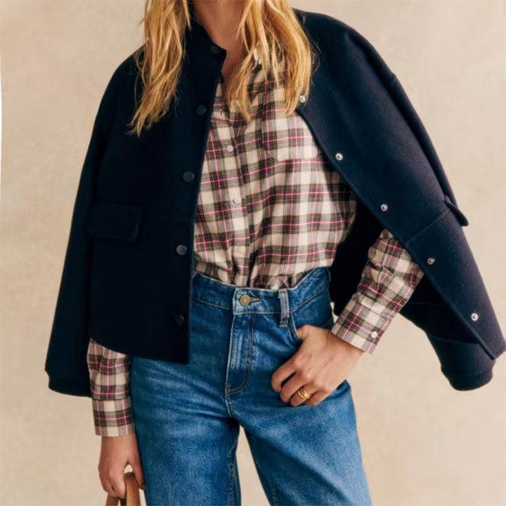 Modern short jacket for women with button details and side pockets. Chic and style