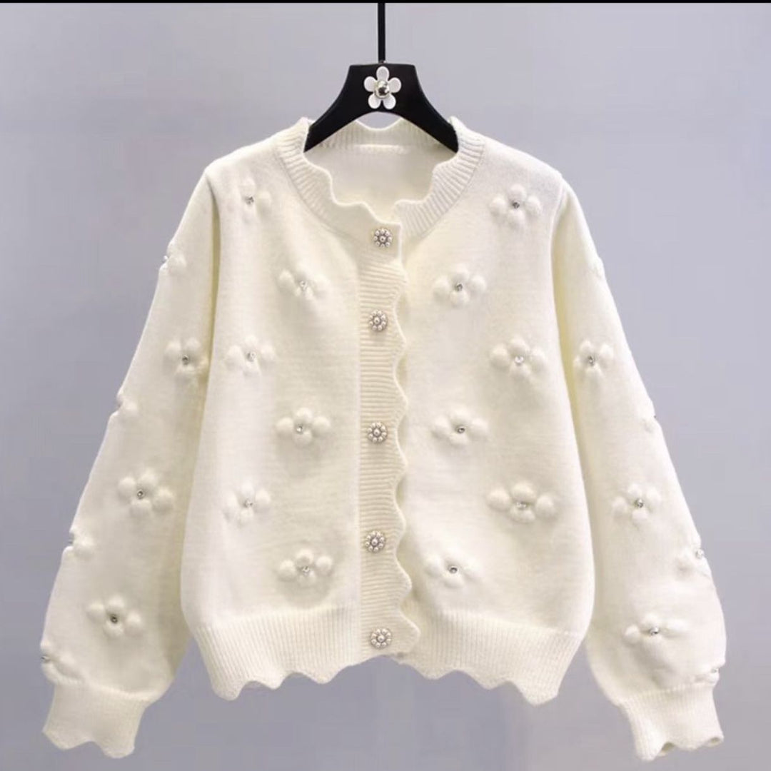 Ladies playful knit vest with decorative pearl buttons and floral design Lune London