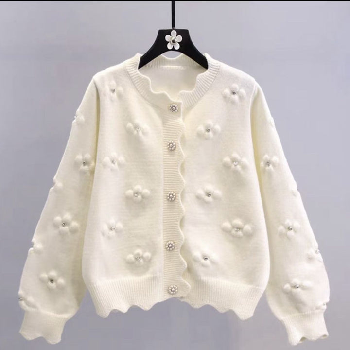 Ladies playful knit vest with decorative pearl buttons and floral design Lune London