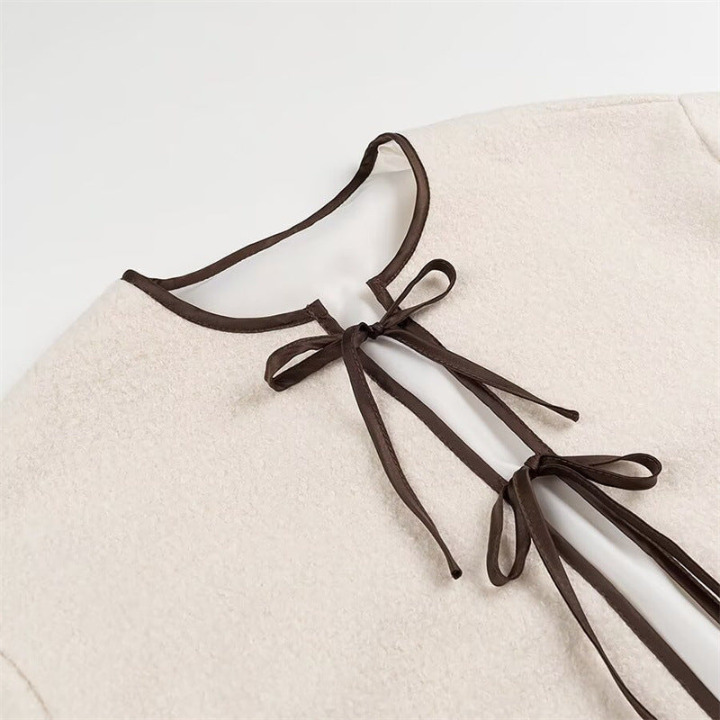 Fashion women's transitional jacket with decorative drawstring and side pockets.