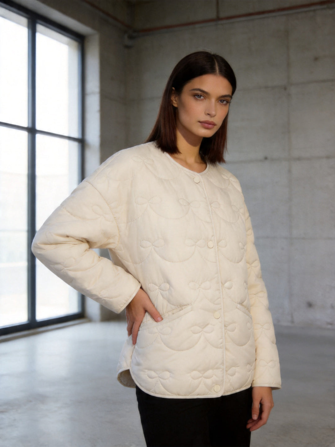 Women's short cut quilted jacket with round neckline and tonal bow quilting Amarae
