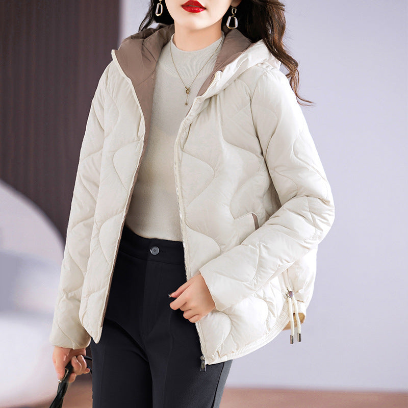 Insulated quilted jacket for women with high collar and practical zip pockets Lune London