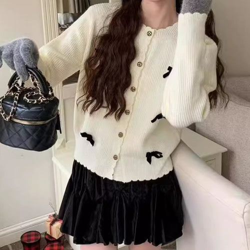 Women's knitted jacket with a playful design and decorative button details Amarae
