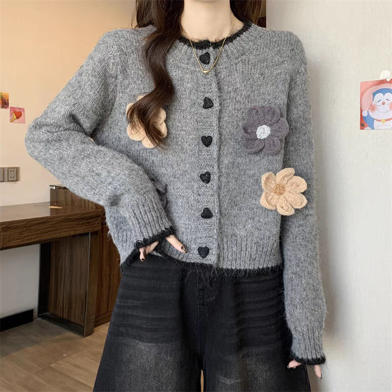 Ladies playful pullover with heart-shaped button closure and floral appliqués Lune London
