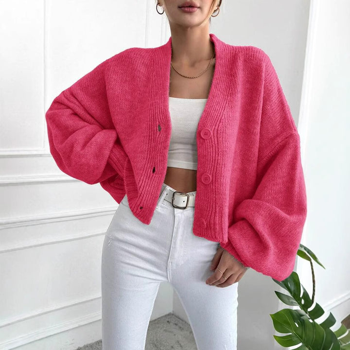 Women's oversized knitted cardigan with voluminous sleeves and chic button details