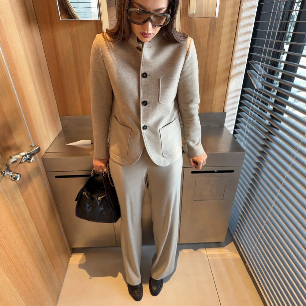 Women's tailored jacket blazer made of wool mix with stand-up collar, curved hem, and patch pockets.