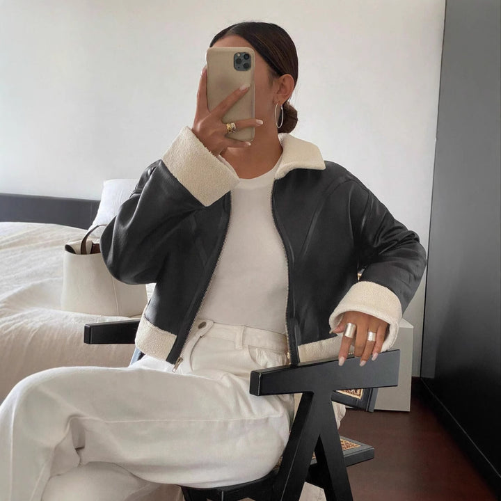Faux leather jacket for women in modern biker style with fur collar and short sleeves Lune London