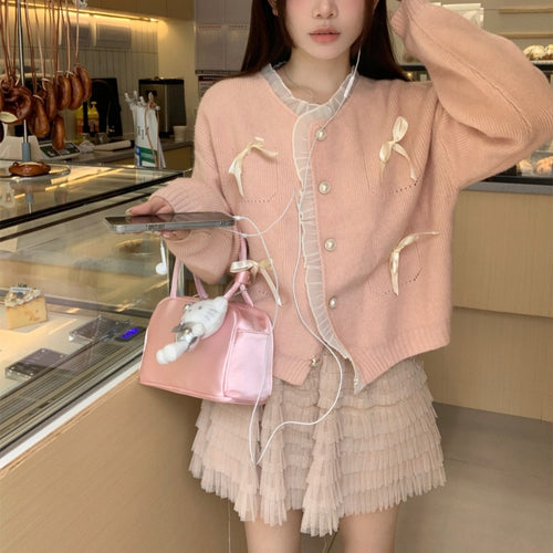 Knitted ladies' jacket with playful knots and pearl buttons Amarae