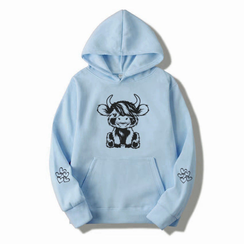 Women's hooded sweatshirt with charming cow motif and practical kangaroo pockets Lune London