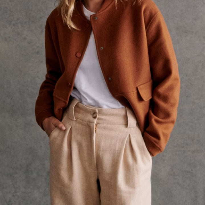Modern short jacket for women with button details and side pockets. Chic and style