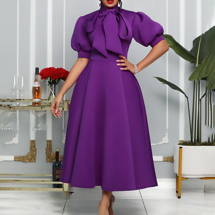 Elegant maxi dress for women with voluminous puff sleeves and a bow neckline Lune London