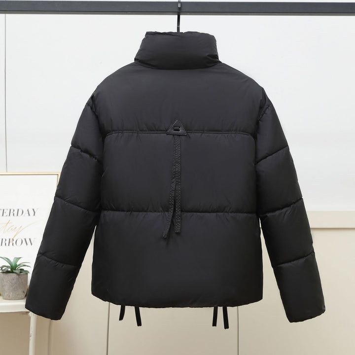 Quilted transitional jacket for women with high collar and practical modern pockets Lune London