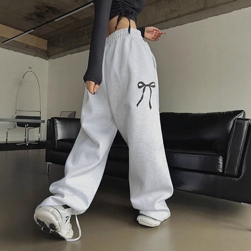 Women's loose leisure pants with elastic waistband and decorative bow motif Chic & Stil