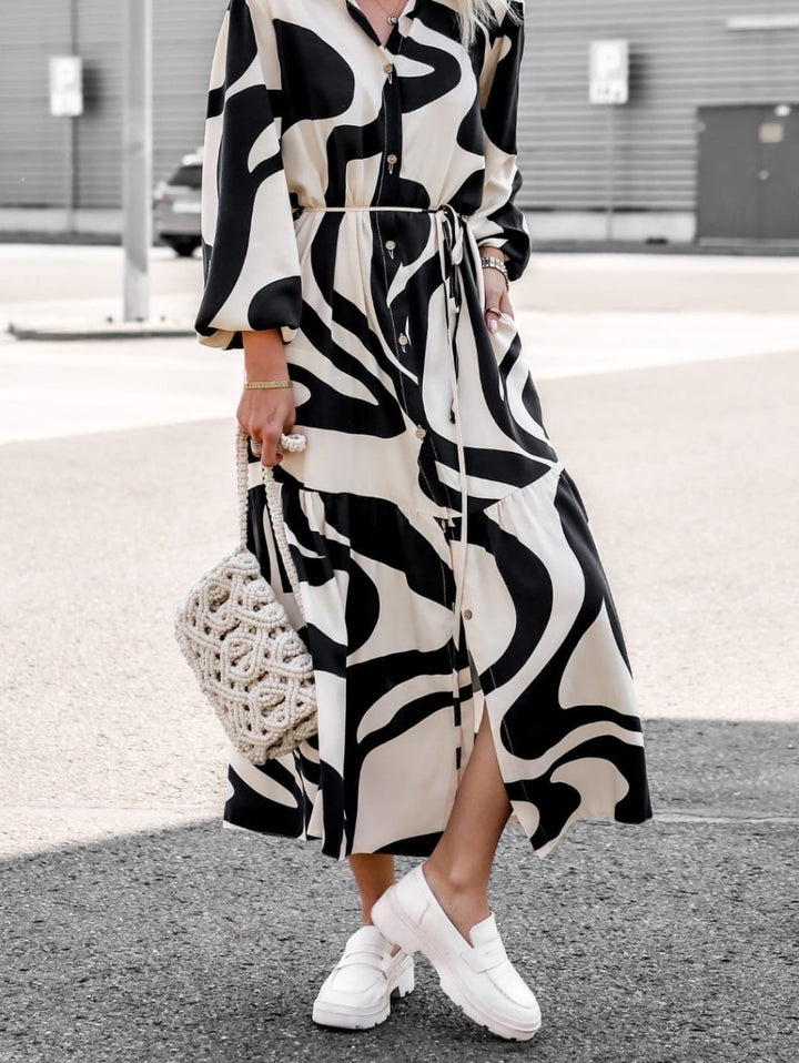 Long sleeve women's dress with trendy pattern and practical belt.