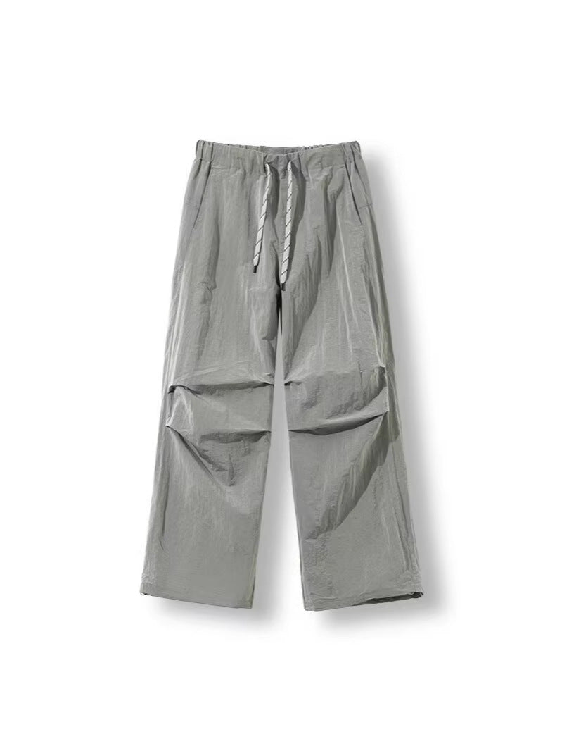 Men's loose-fitting nylon track pants with drawstring, patch pockets, and straight wide-leg fit Amarae