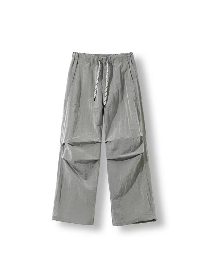 Men's loose-fitting nylon track pants with drawstring, patch pockets, and straight wide-leg fit Amarae