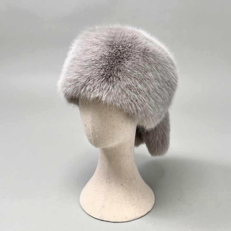 Women’s plush faux fur trapper hat with earflaps and decorative tail Amarae