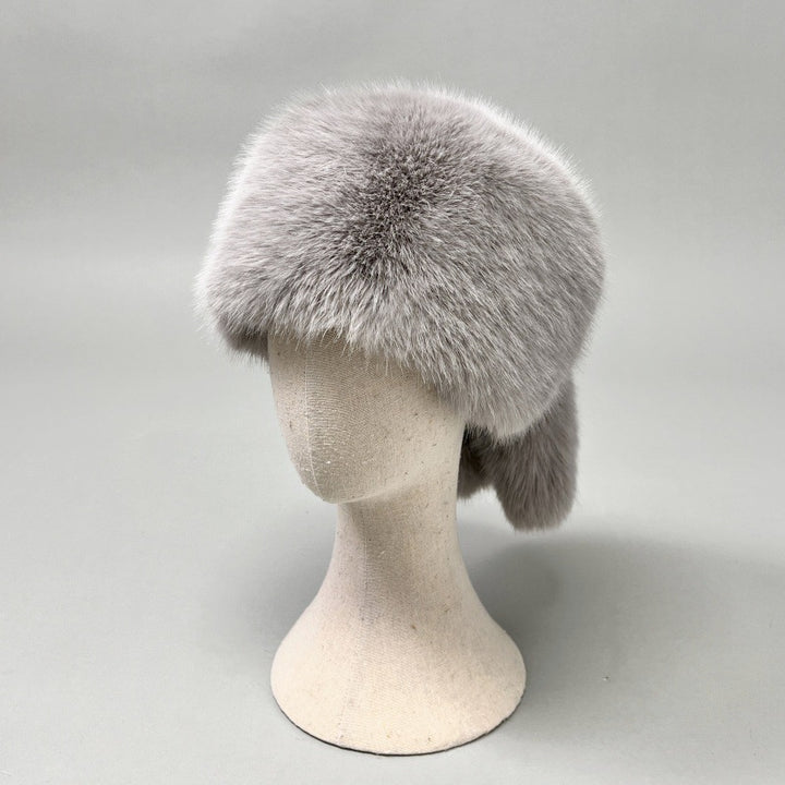 Women’s plush faux fur trapper hat with earflaps and decorative tail Amarae