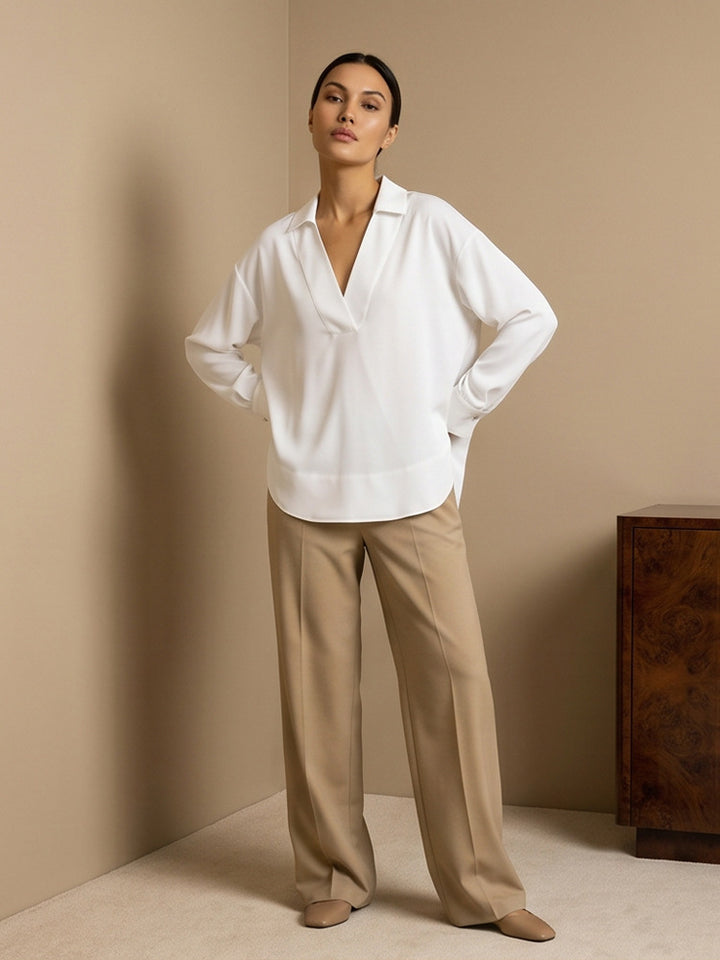 Women's loose-fitting tunic blouse with V-neck, shirt collar, and extended back hem Amarae