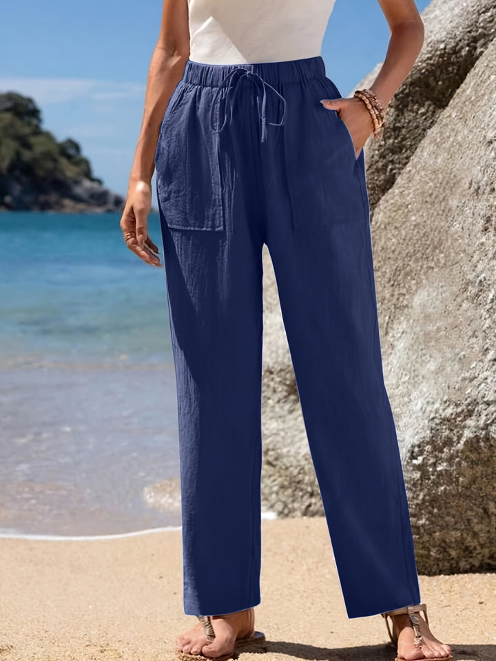 Loose beach pants for women with elastic waistband and practical pockets Lune London
