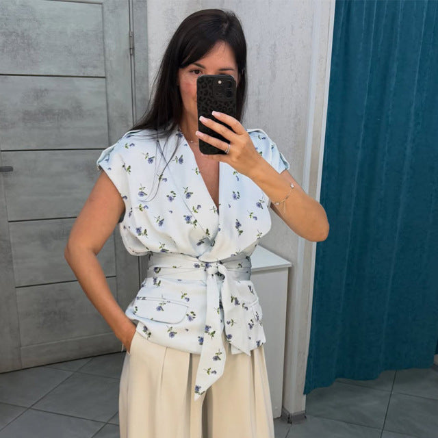 Women's sleeveless wrap blouse with fitted tie belt and patch pockets Amarae