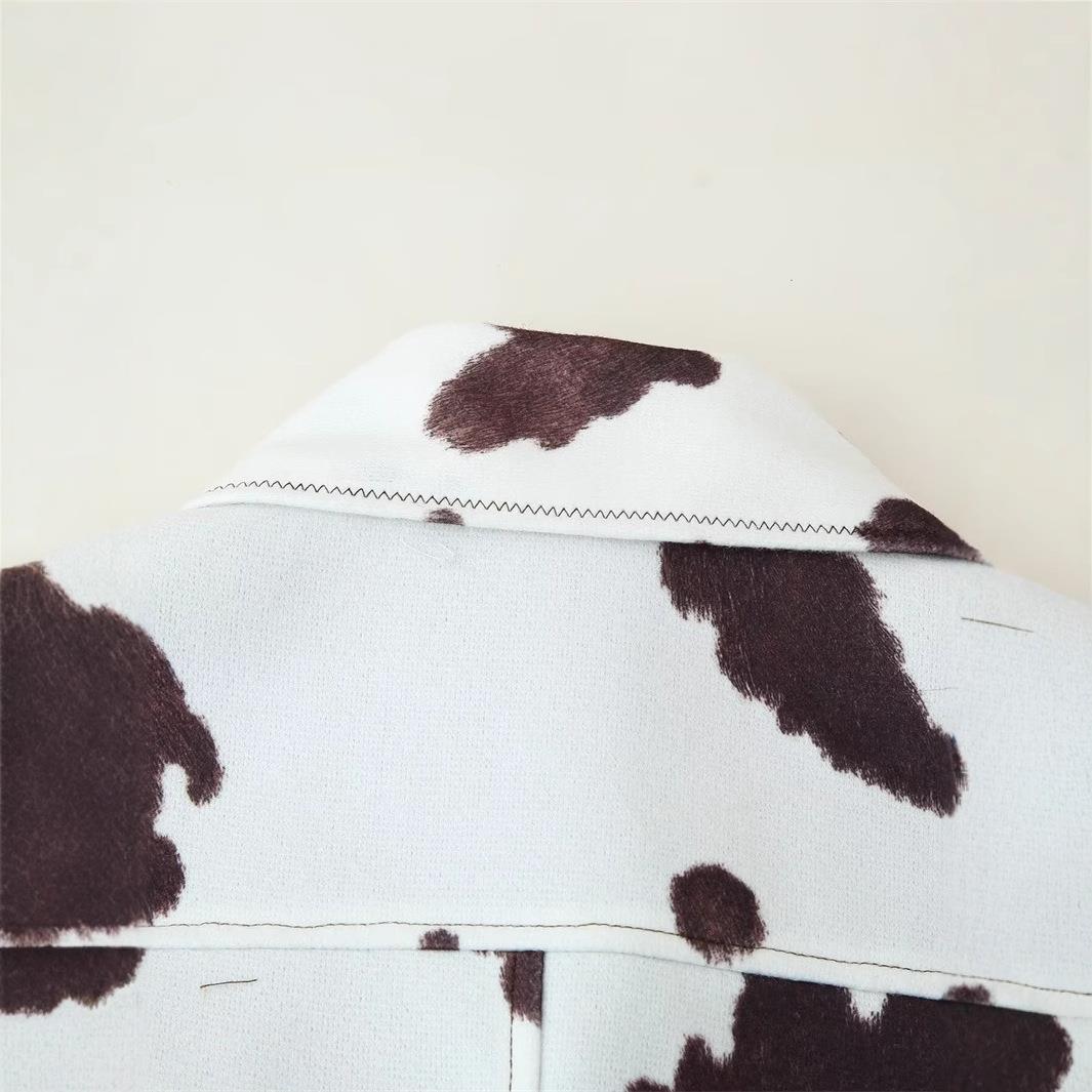 Women's leather jacket with trendy cow spot design and elegant button list Lune London