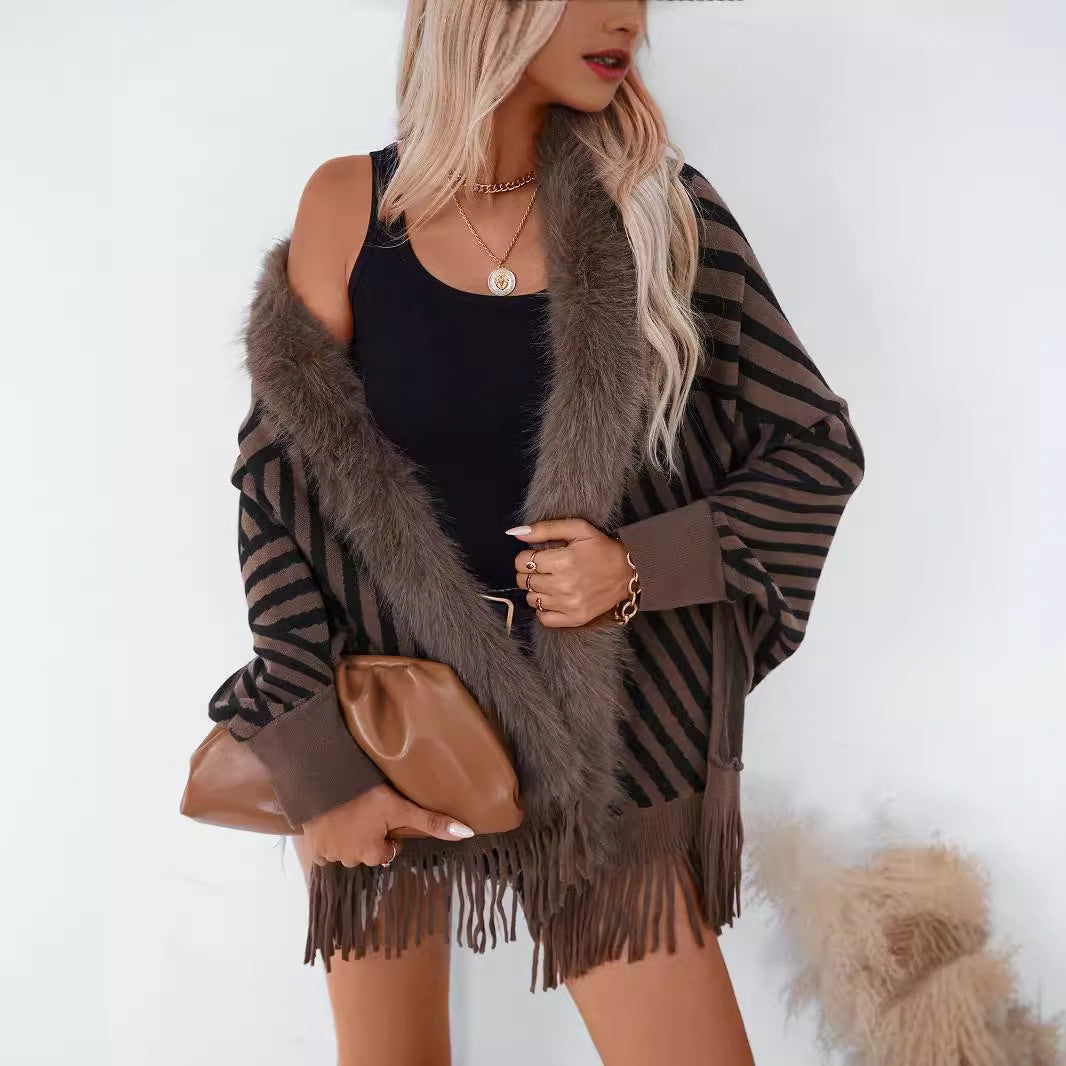 Ladies knitted poncho with elegant faux fur collar and fringe design Lune London