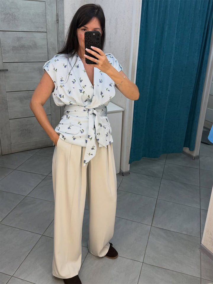 Women's sleeveless wrap blouse with fitted tie belt and patch pockets Amarae