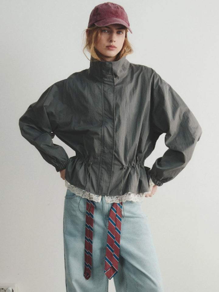 Women's oversized windbreaker with high stand-up collar, drawstring waist, and elastic cuffs