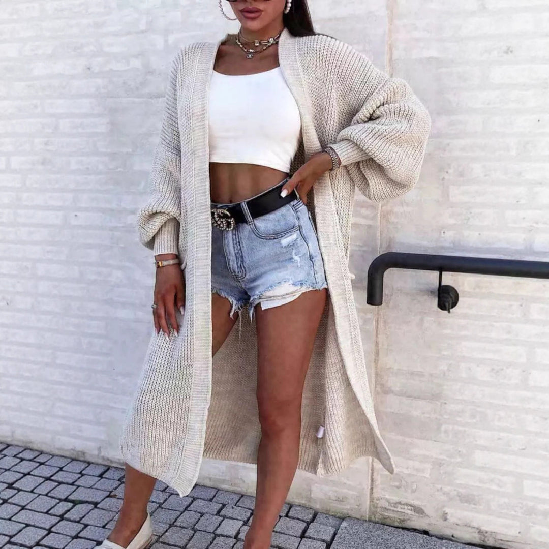 Long knitted coat for women with oversized sleeves and practical pockets Lune London