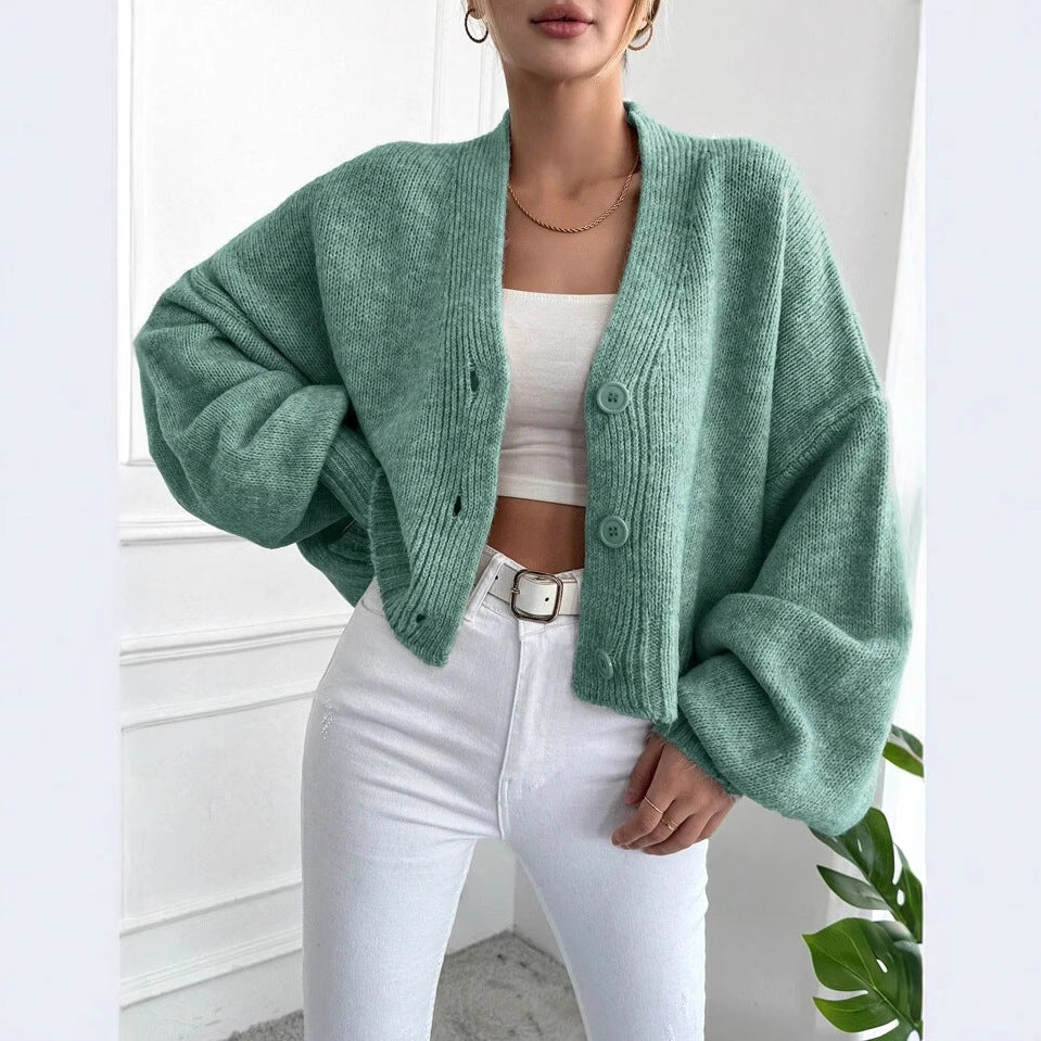 Women's oversized knitted cardigan with voluminous sleeves and chic button details
