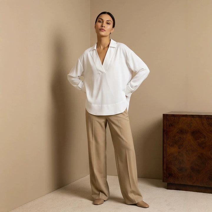 Women's loose-fitting tunic blouse with V-neck, shirt collar, and extended back hem Amarae