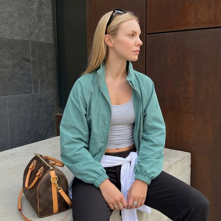Ladies sporty-urban windbreaker with short cropped cut, high stand-up collar and elastic cuffs