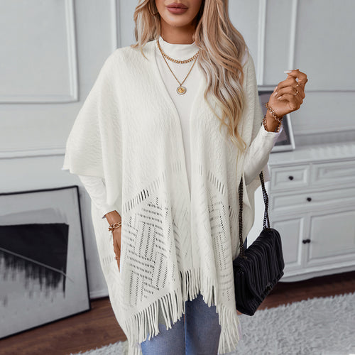 Elegant knitted poncho for women with fringe details and a distinctive pattern Amarae