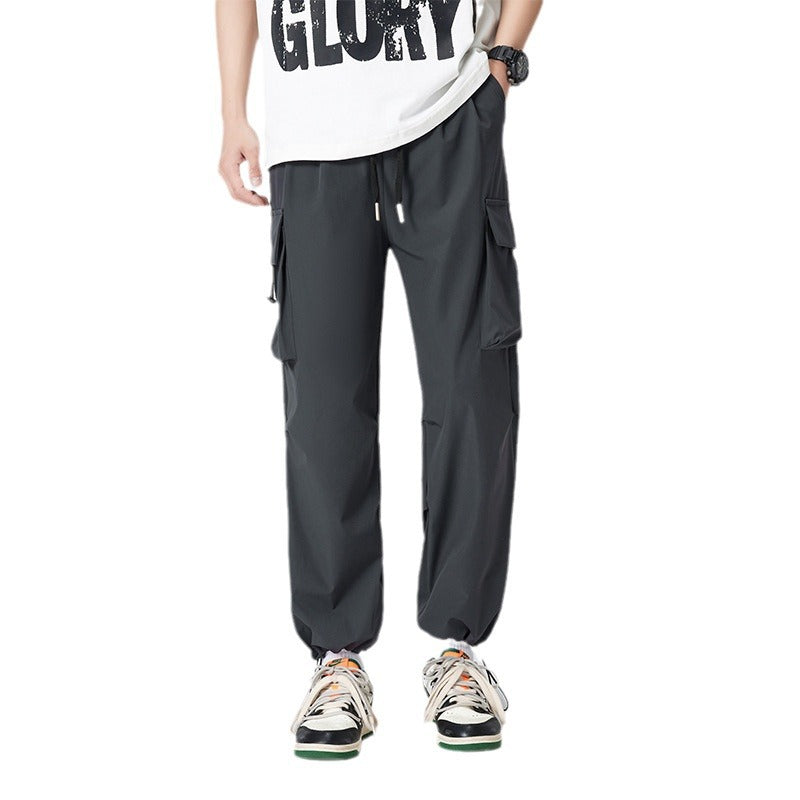 Women’s cargo pants in outdoor style with drawstring waistband, large side pockets, and adjustable hem.