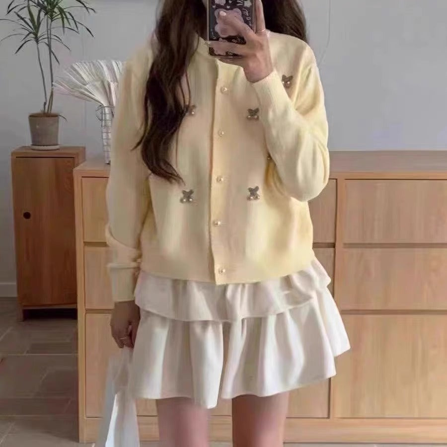 Women's knit jacket with a playful design and chic pearl buttons