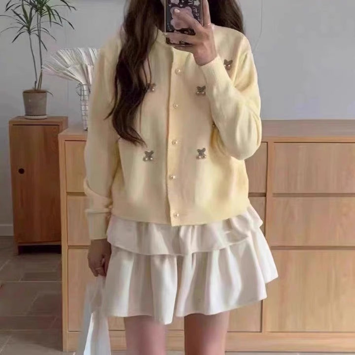 Women's knit jacket with a playful design and chic pearl buttons