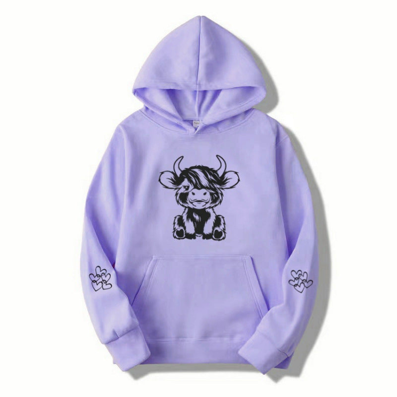 Women's hooded sweatshirt with charming cow motif and practical kangaroo pockets Lune London