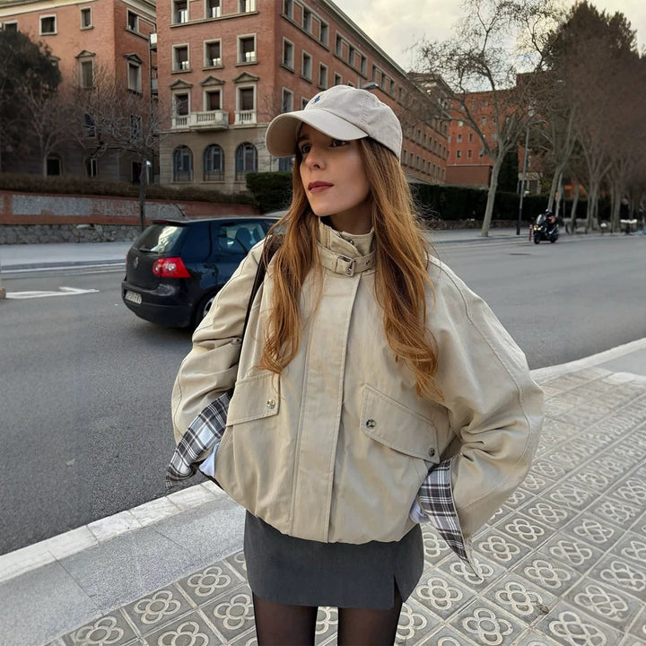 Women’s short bomber jacket with stand-up collar, chin strap, and checkered sleeve lining Amarae