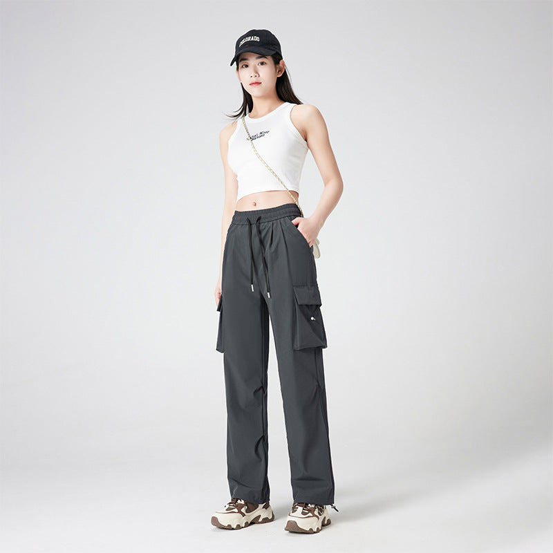Women’s cargo pants in outdoor style with drawstring waistband, large side pockets, and adjustable hem.