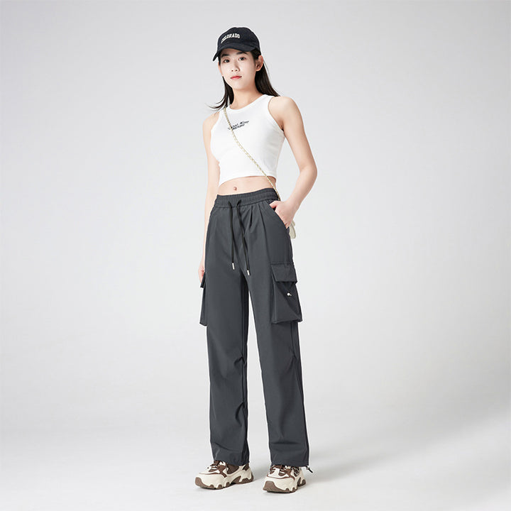 Women’s cargo pants in outdoor style with drawstring waistband, large side pockets, and adjustable hem.