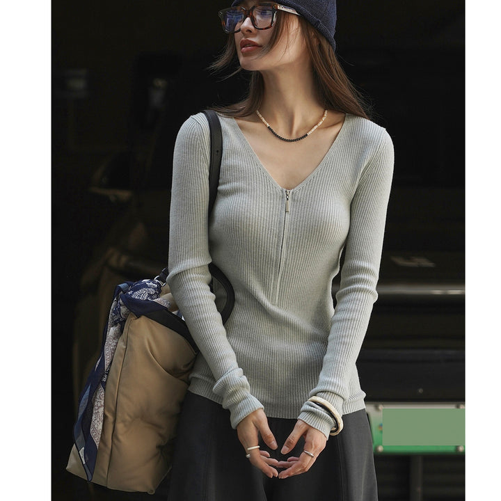 Women's fitted ribbed top with visible zipper at the back