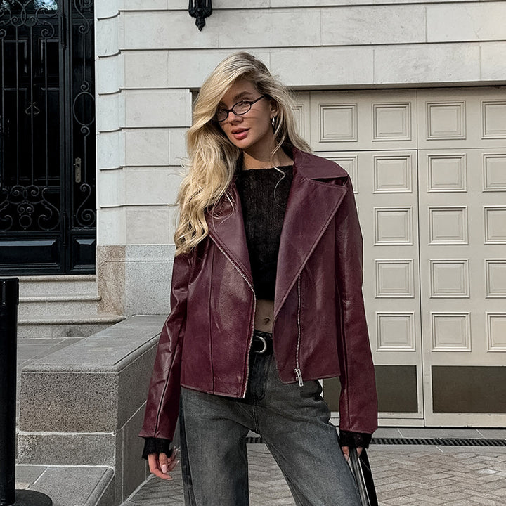 Synthetic leather biker jacket for women with a slim fit and chic metal zippers.