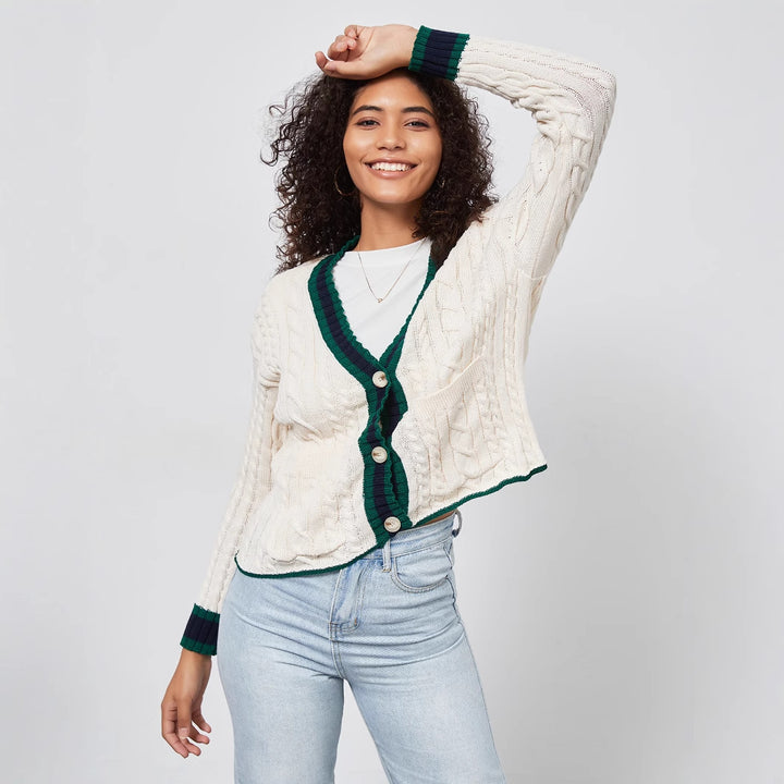 Chunky knit cardigan for women with decorative button placket and matching hem.