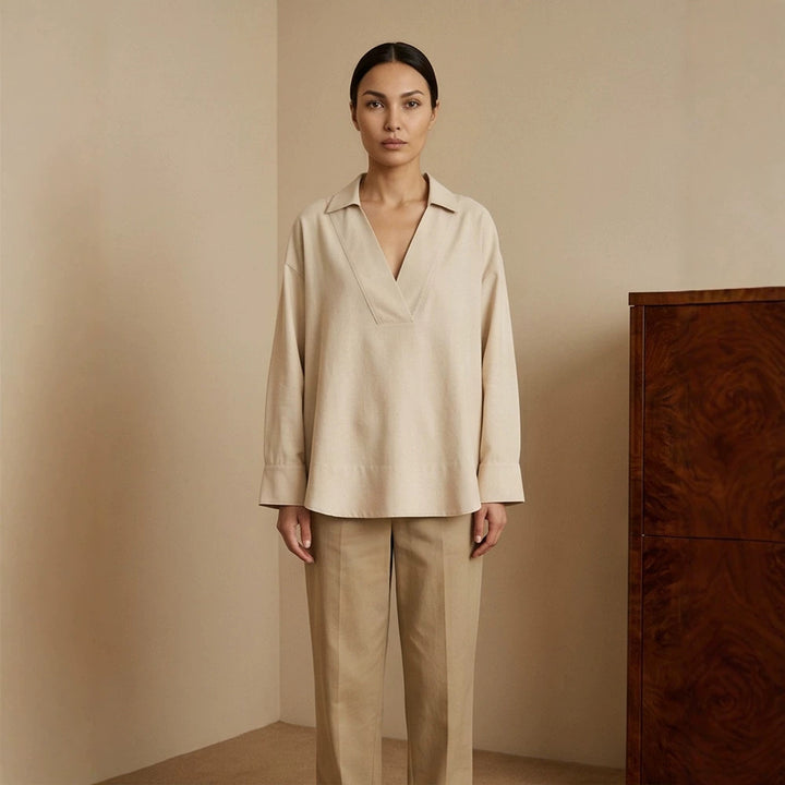 Women's loose-fitting tunic blouse with V-neck, shirt collar, and extended back hem Amarae