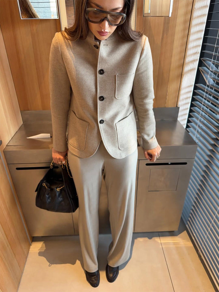 Women's tailored jacket blazer made of wool mix with stand-up collar, curved hem, and patch pockets.
