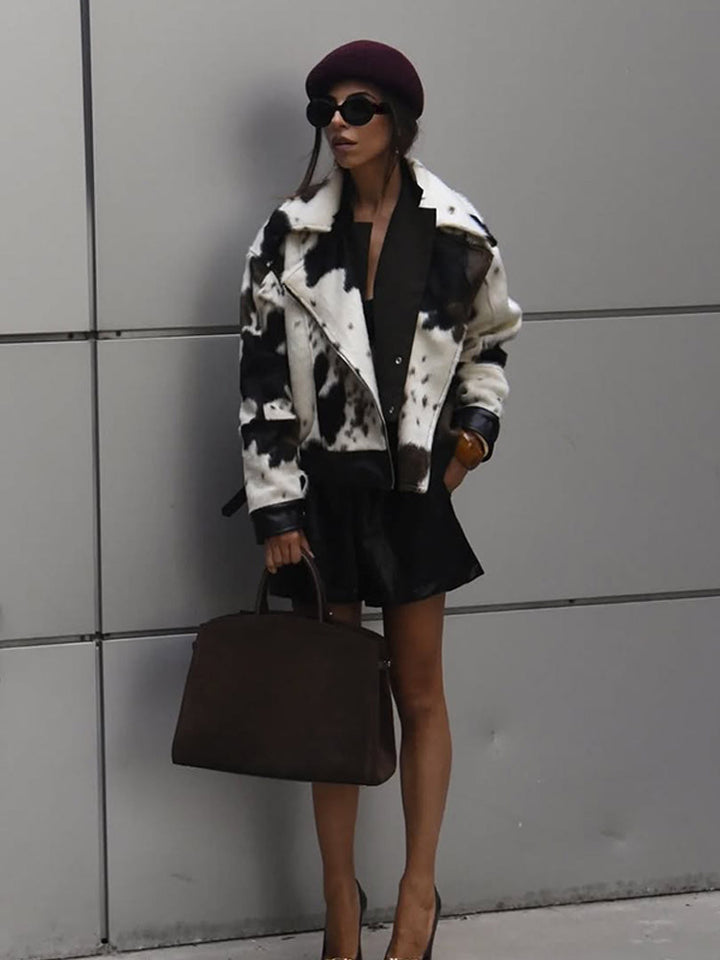 Women short padded biker jacket made of faux fur in cow print with contrast leather trim Amarae